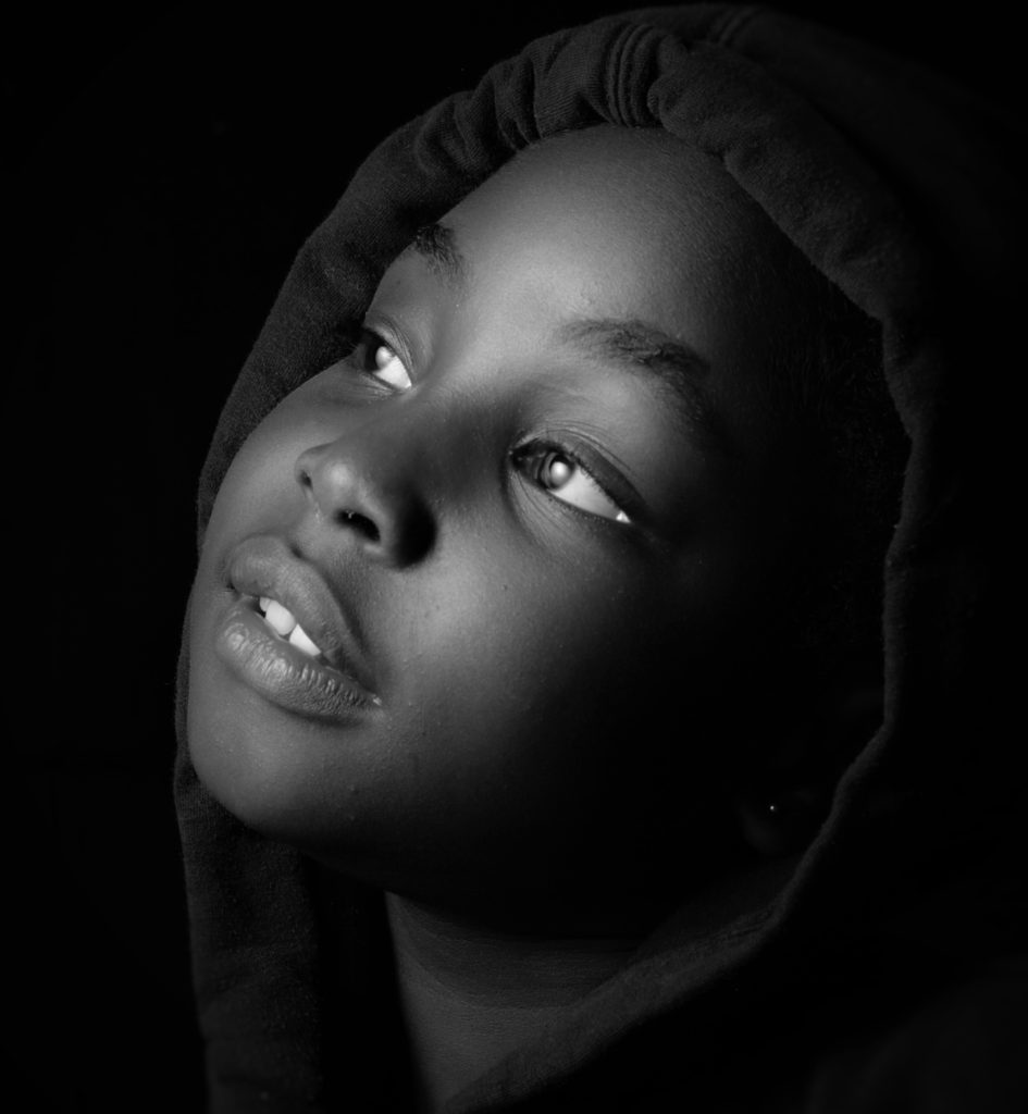 Innocent child waits in the darkness for her parents.