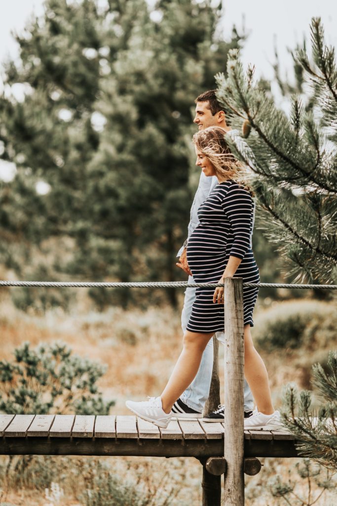 Happy expectant couple walking together to keep a bright outlook.