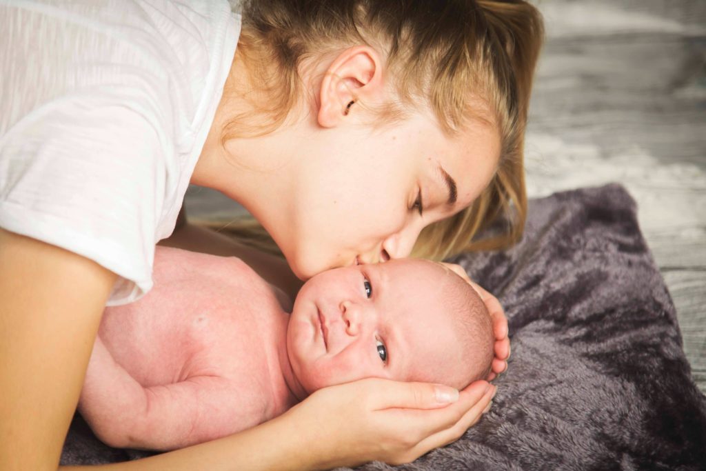 This mom kisses her baby after severe chronic depression is lifted by IV ketamine.